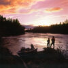 Discover the Best Kenai Alaska Fishing Lodges Northern shoreline fishing,Canada,Two people standing on the shore fishing at dusk.
